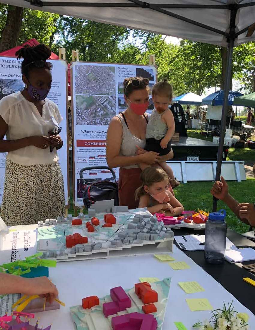 People check out a community planning tent